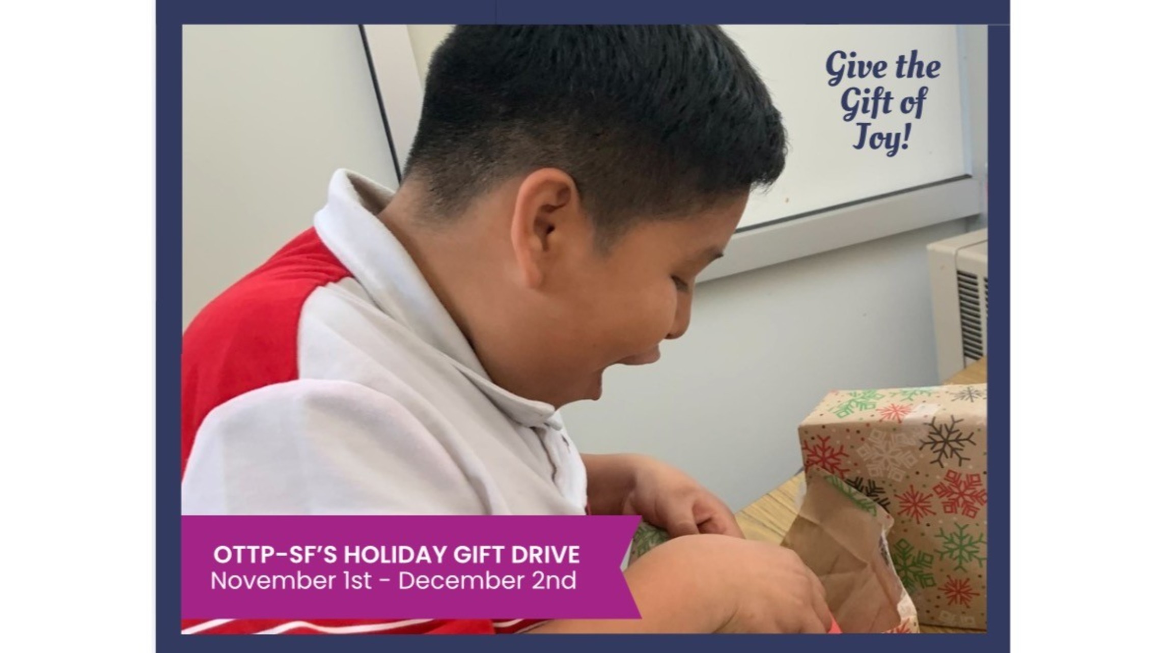 Picture of young boy opening a gift with a smile on his face