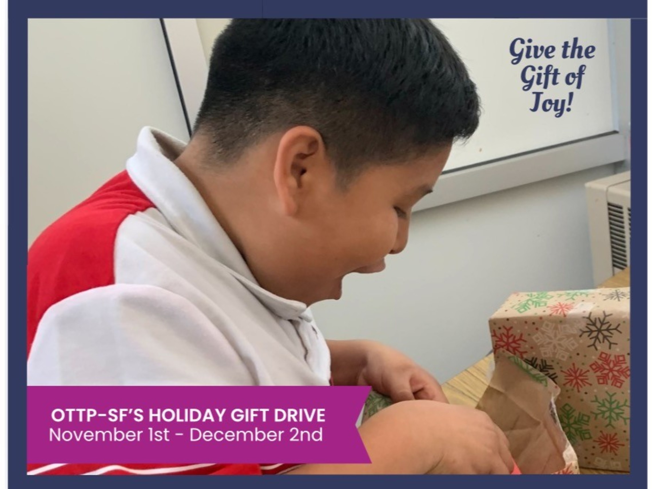 Picture of young boy opening a gift with a smile on his face